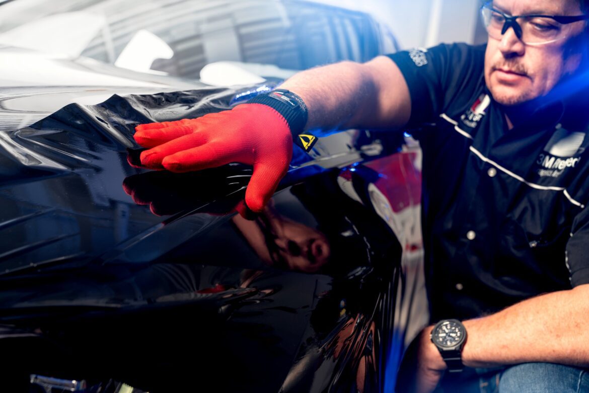 A person with red gloves on and a watch