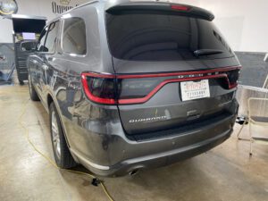 A gray dodge durango parked in a garage.