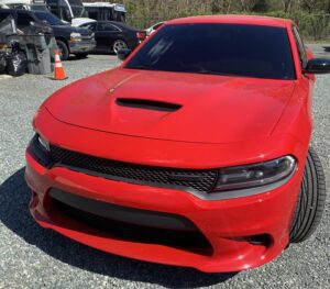 A red car parked in the parking lot