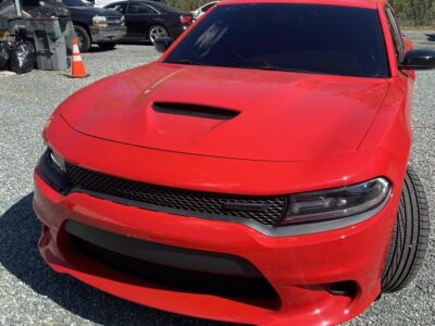 A red car parked in the parking lot