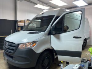 A white van is parked in the garage.