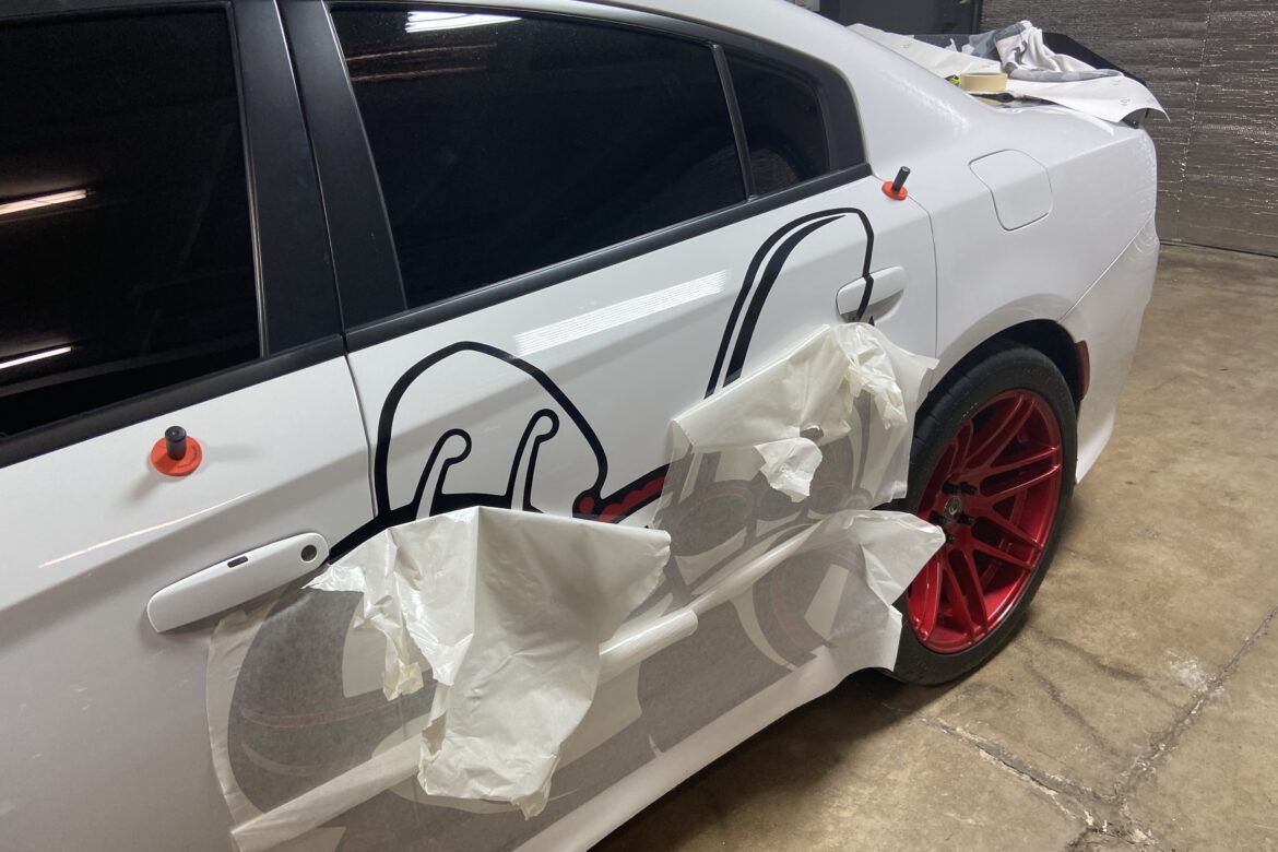 A white car with some black and red drawings on it