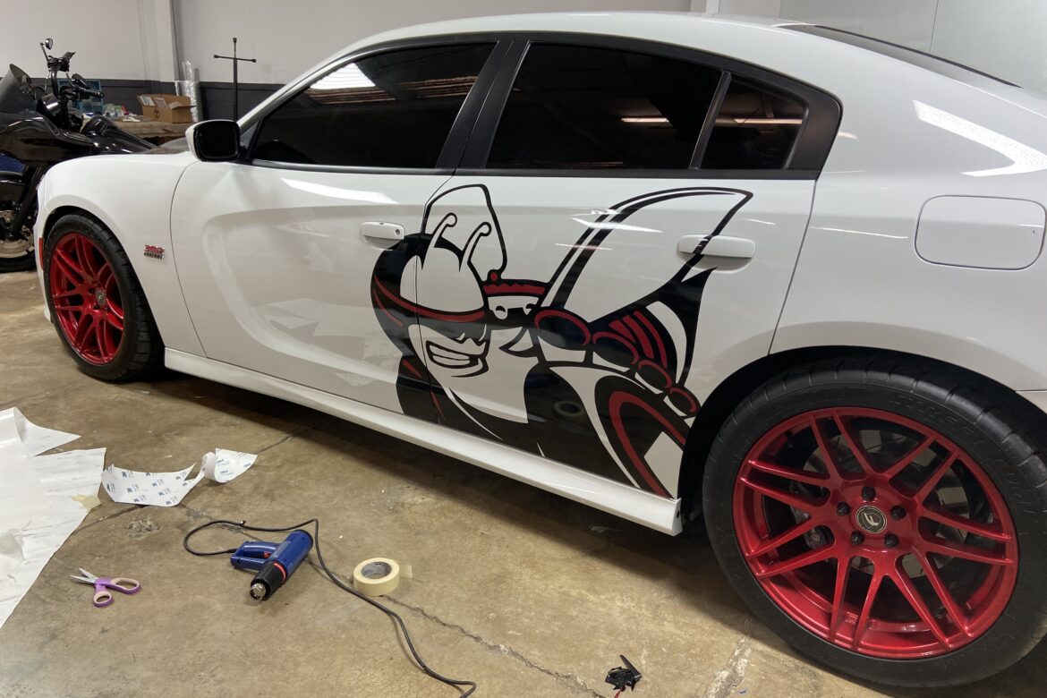 A white car with red and black designs on the side.