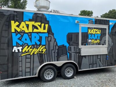 A food truck parked on the side of a road.