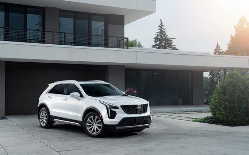 A white car parked in front of a building.