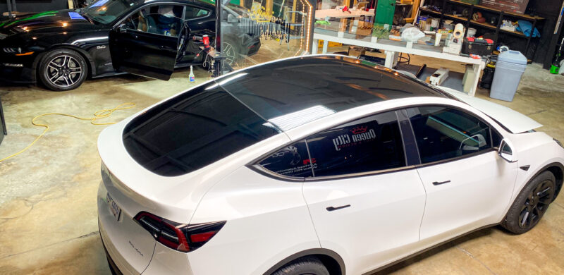 A white tesla model x parked in a showroom.