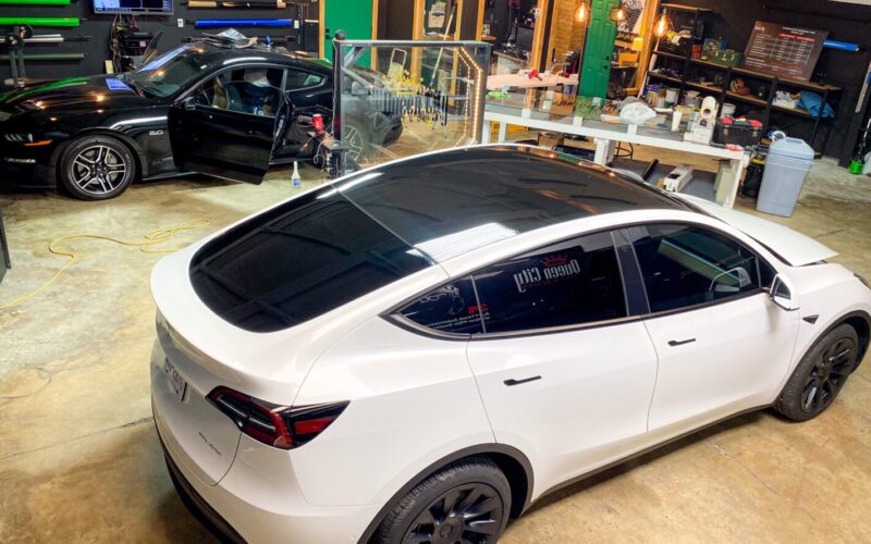 A white tesla model x parked in a showroom.