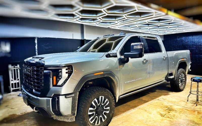 Silver GMC Denali HD truck parked.