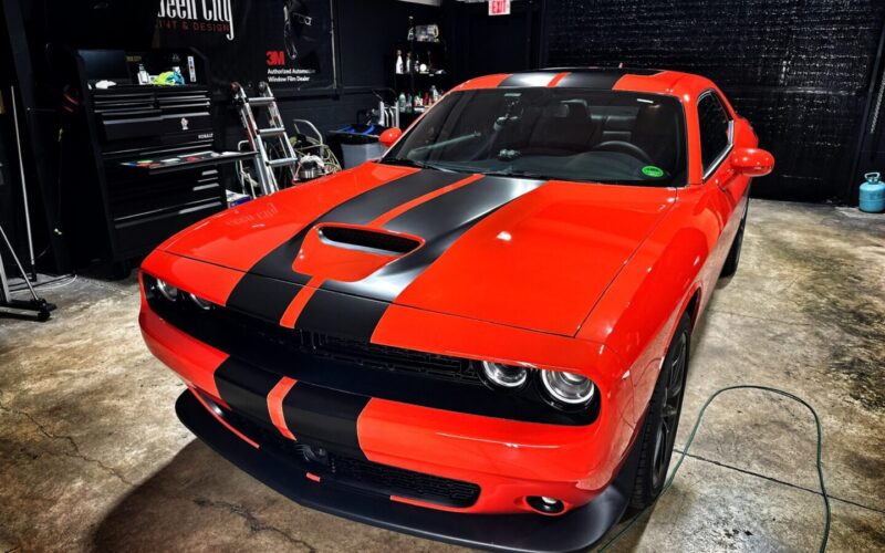 Red Dodge Challenger with black stripes.